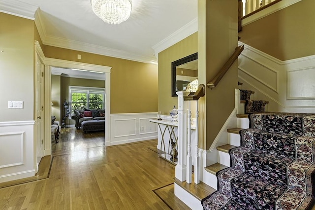 26 Waterville Ln, Shrewsbury, MA 01545 - staircase featuring a decorative wall, crown molding, a chandelier, wood finished floors, and wainscoting