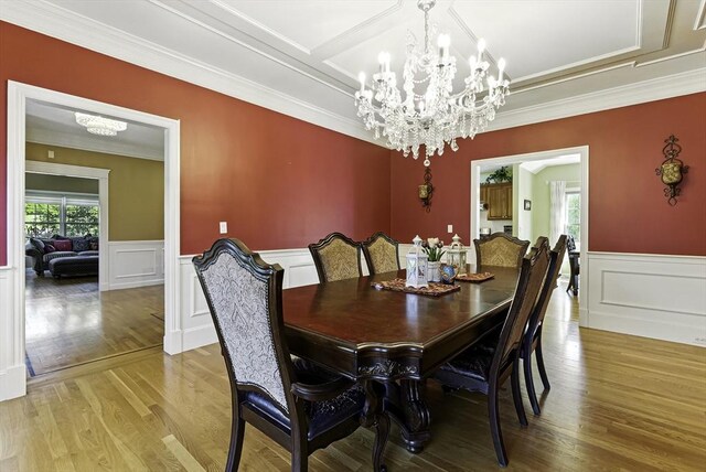 26 Waterville Ln, Shrewsbury, MA 01545 - dining room featuring a chandelier, light wood-type flooring, crown molding, a wainscoted wall, and a decorative wall
