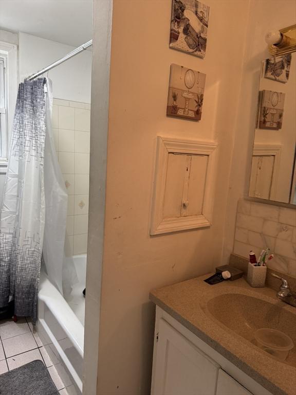 348 Fairmount St, Fitchburg, MA 01420 - bathroom featuring vanity, tile patterned flooring, and shower / tub combo with curtain