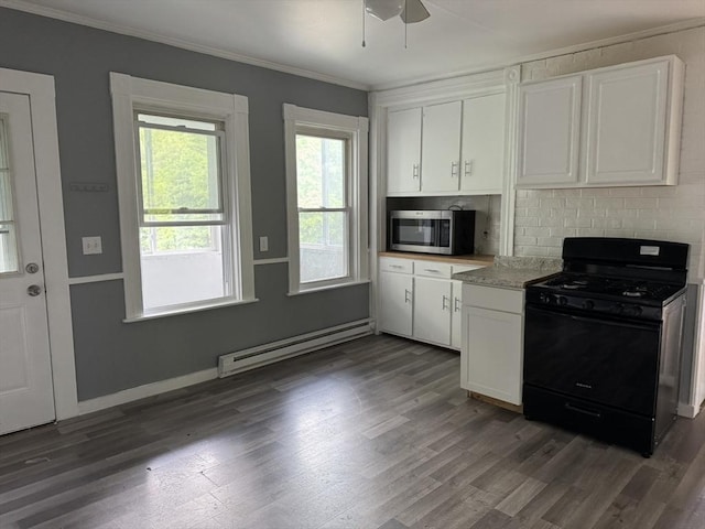 348 Fairmount St, Fitchburg, MA 01420 - kitchen with black gas range, stainless steel microwave, a baseboard radiator, dark wood finished floors, and white cabinetry