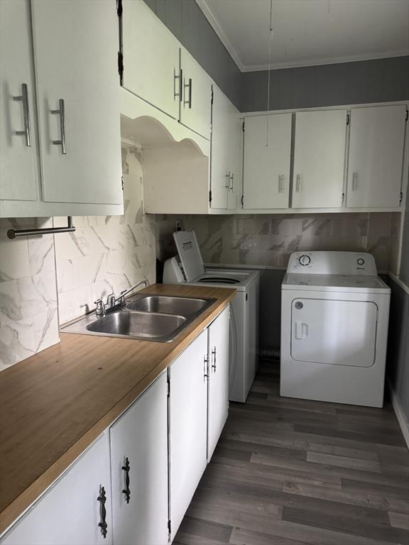 348 Fairmount St, Fitchburg, MA 01420 - kitchen with a sink, ornamental molding, separate washer and dryer, decorative backsplash, and dark wood-type flooring