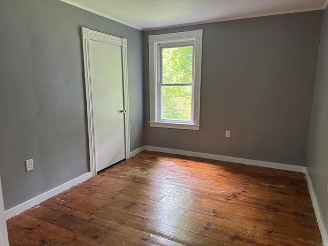 348 Fairmount St, Fitchburg, MA 01420 - unfurnished bedroom featuring hardwood / wood-style flooring, ornamental molding, and baseboards