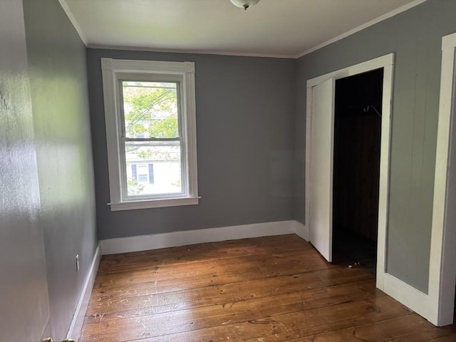 348 Fairmount St, Fitchburg, MA 01420 - unfurnished bedroom with hardwood / wood-style floors, ornamental molding, baseboards, and a closet