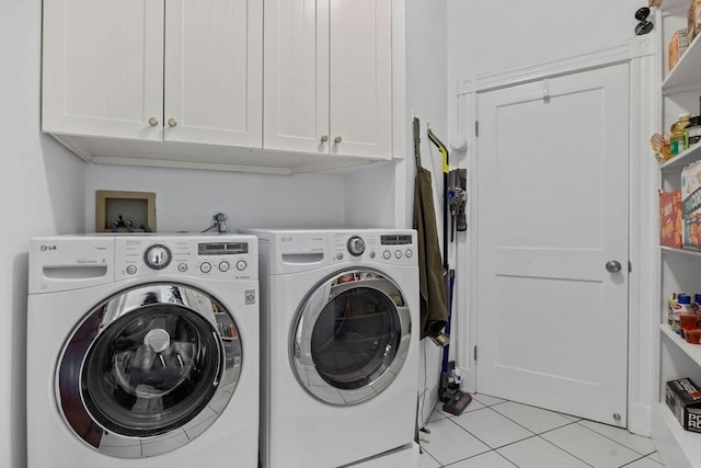 laundry room featuring cabinet space, independent washer and dryer, and light tile patterned flooring