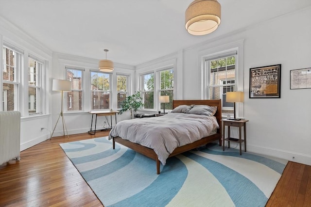 bedroom featuring baseboards and wood finished floors