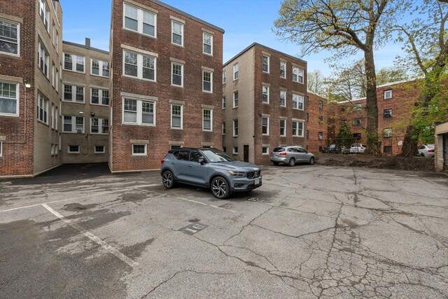 view of building exterior with uncovered parking