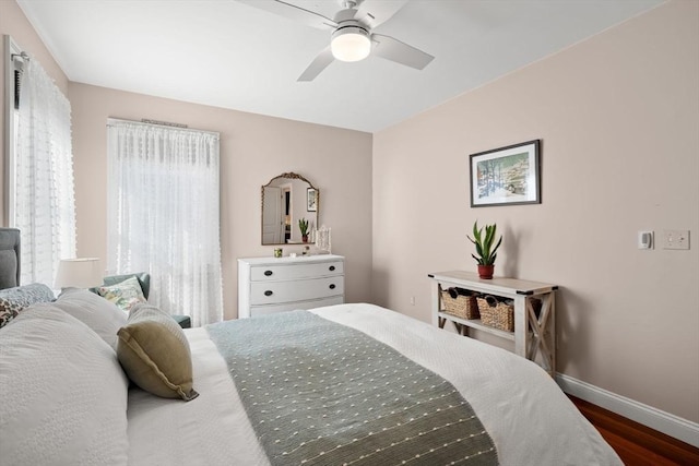 bedroom with dark wood-type flooring and ceiling fan