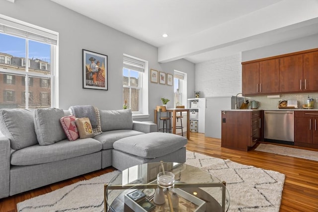 living area featuring light wood-style floors, recessed lighting, and a healthy amount of sunlight