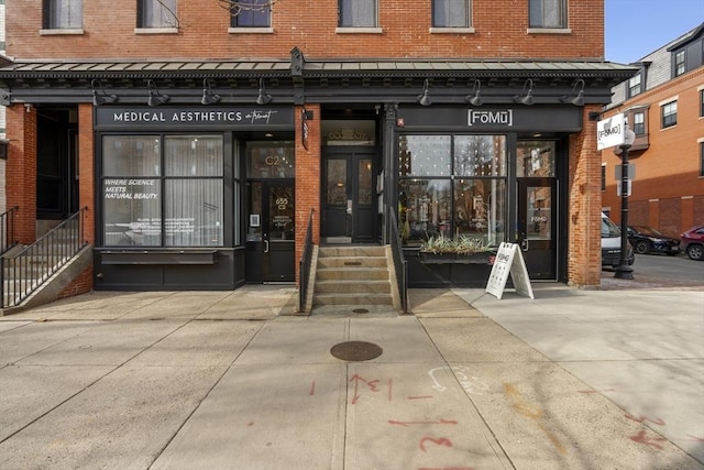 entrance to property featuring brick siding