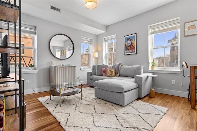 sitting room featuring visible vents, baseboards, and wood finished floors