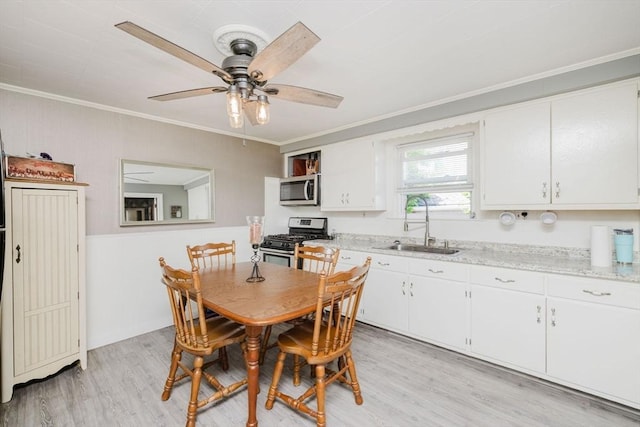 20 Wilcox St, Fall River, MA 02724 - dining area featuring light wood-style flooring, ornamental molding, and a ceiling fan