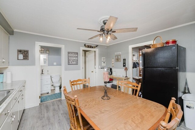 20 Wilcox St, Fall River, MA 02724 - dining area with a ceiling fan, a wainscoted wall, light wood-style flooring, and crown molding