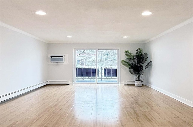 spare room with light wood-type flooring, crown molding, a wall unit AC, and a baseboard heating unit