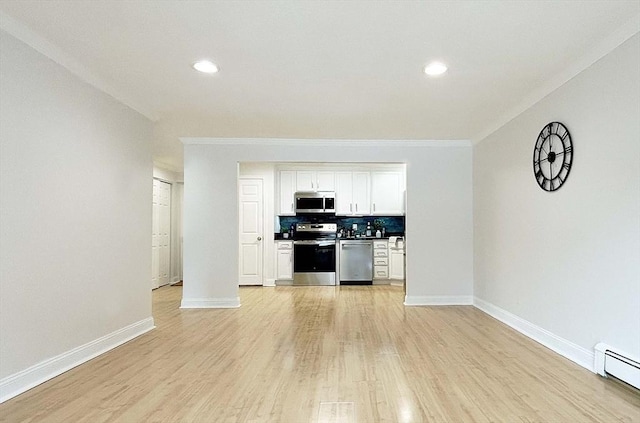 unfurnished living room with baseboard heating, crown molding, and light hardwood / wood-style floors