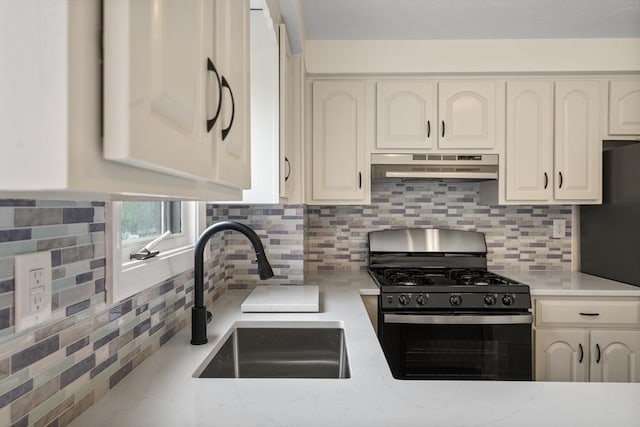 20 Washington St Unit 15, Easton, MA 02356 - kitchen with black appliances, under cabinet range hood, a sink, and backsplash