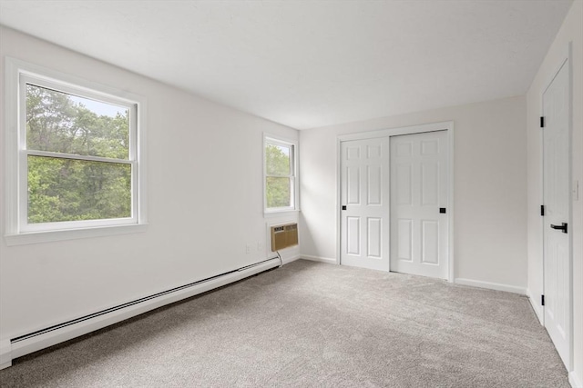 20 Washington St Unit 15, Easton, MA 02356 - unfurnished bedroom featuring baseboard heating, carpet flooring, baseboards, and a closet