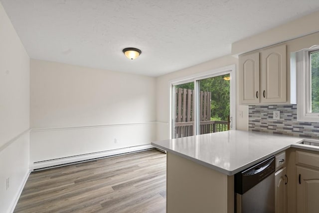20 Washington St Unit 15, Easton, MA 02356 - kitchen featuring dishwasher, baseboard heating, a peninsula, decorative backsplash, and light countertops