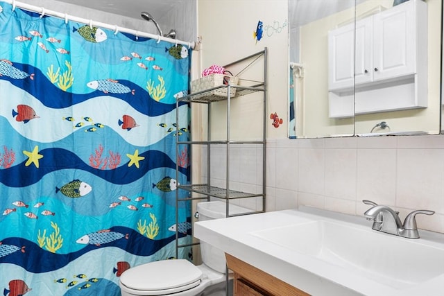 bathroom featuring vanity, tile walls, toilet, and walk in shower