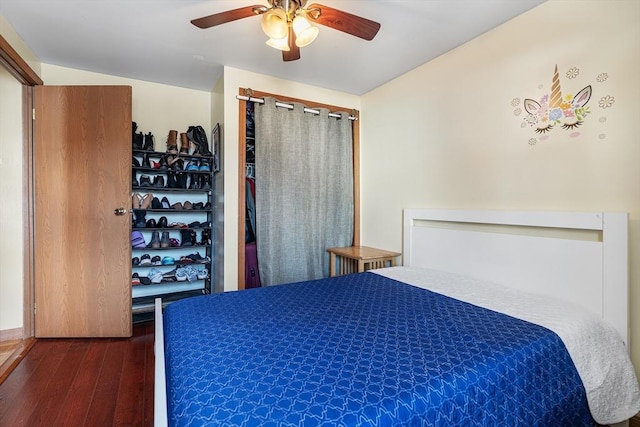 bedroom featuring ceiling fan and dark hardwood / wood-style floors