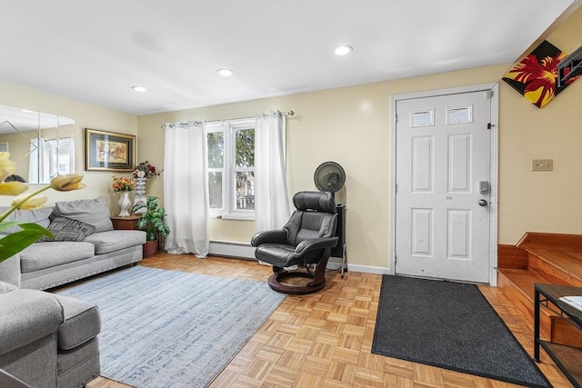 living room featuring light parquet flooring and baseboard heating