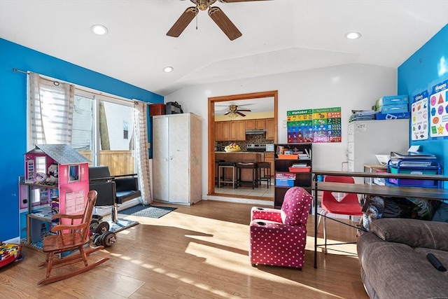 office with vaulted ceiling, hardwood / wood-style floors, and ceiling fan