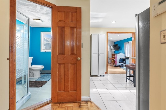 hallway featuring a baseboard radiator and light parquet floors