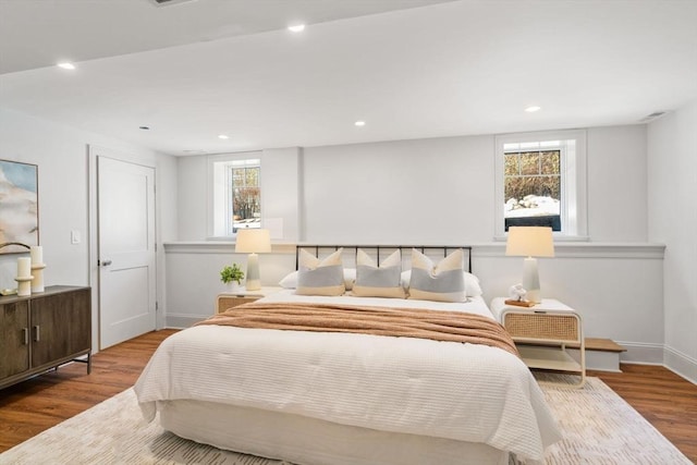 bedroom with recessed lighting, baseboards, and wood finished floors