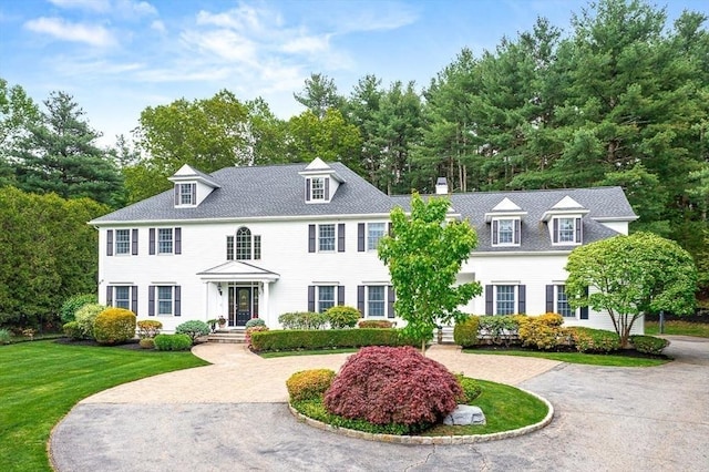 130 Bridle Trail Rd, Needham, MA 02492 - view of front facade featuring a chimney, curved driveway, and a front yard