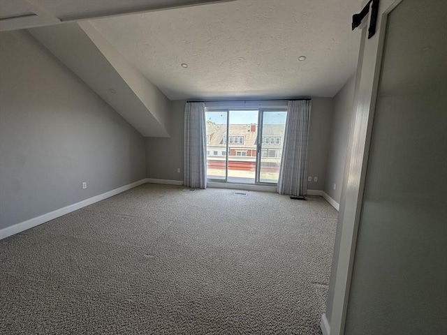 158 Quincy Shore Dr Unit 78, Quincy, MA 02171 - additional living space featuring light colored carpet and a textured ceiling
