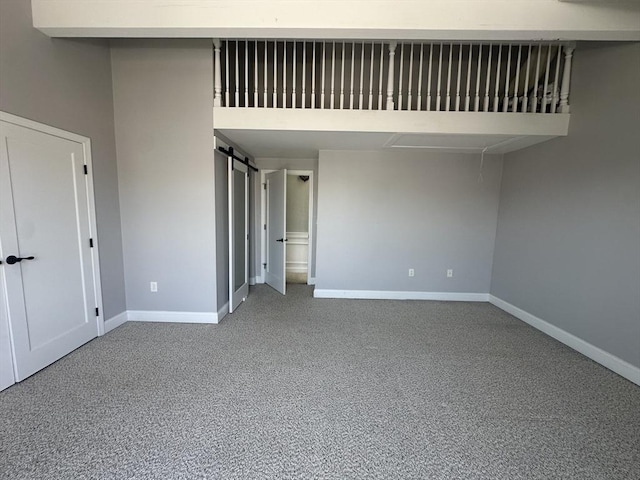158 Quincy Shore Dr Unit 78, Quincy, MA 02171 - unfurnished bedroom with carpet floors and a barn door