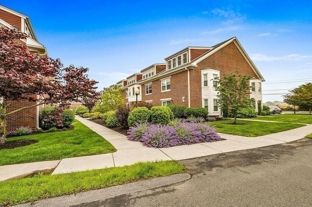 158 Quincy Shore Dr Unit 78, Quincy, MA 02171 - view of side of home with brick siding and a lawn