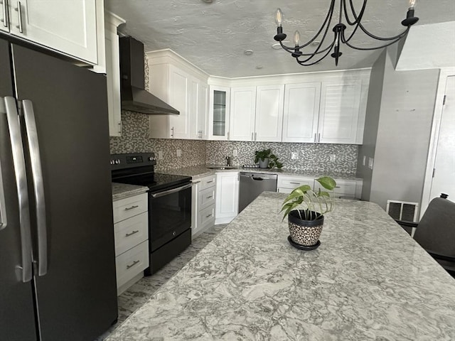 158 Quincy Shore Dr Unit 78, Quincy, MA 02171 - kitchen featuring appliances with stainless steel finishes, wall chimney exhaust hood, white cabinets, a chandelier, and light stone counters