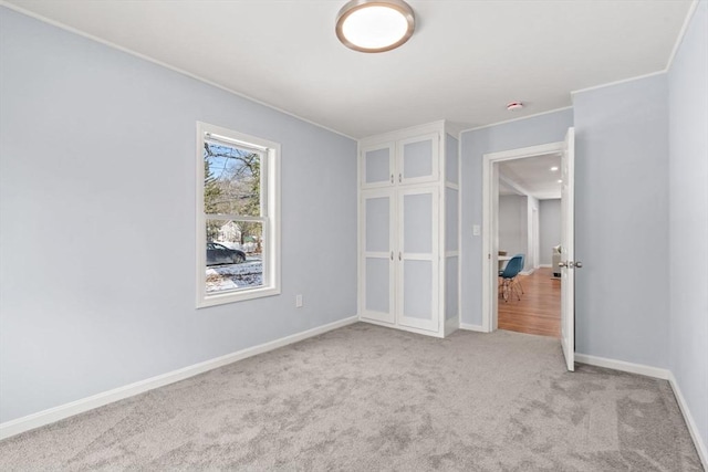 unfurnished room with light colored carpet