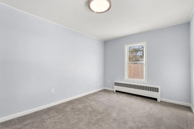 empty room with radiator and carpet