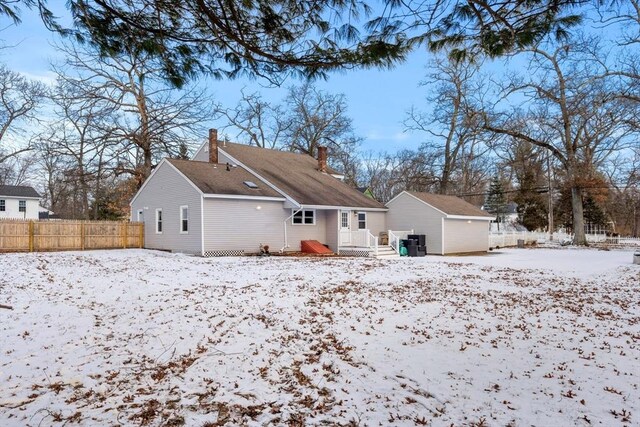 view of snow covered rear of property