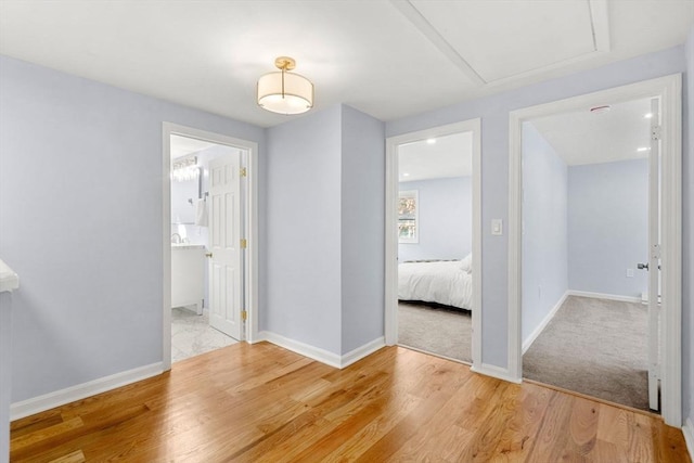 corridor with light hardwood / wood-style flooring