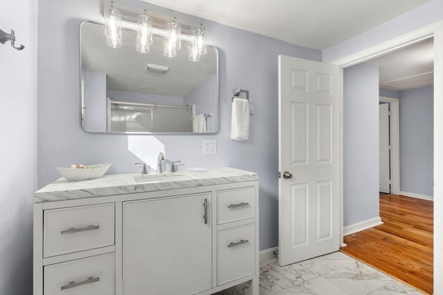 bathroom with walk in shower and vanity