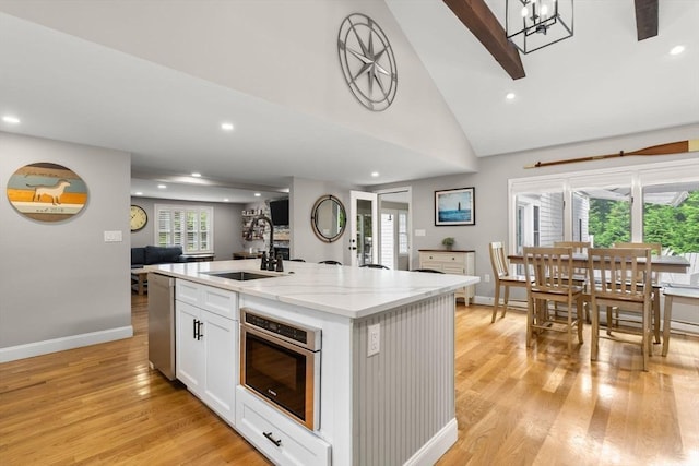 85 Mann Hill Rd, Scituate, MA 02066 - kitchen featuring stainless steel dishwasher, a center island with sink, recessed lighting, light wood finished floors, and open floor plan