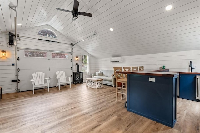 85 Mann Hill Rd, Scituate, MA 02066 - kitchen featuring blue cabinetry, wood counters, lofted ceiling, ceiling fan, and a breakfast bar