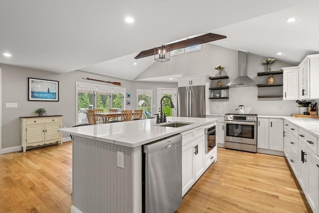 85 Mann Hill Rd, Scituate, MA 02066 - kitchen featuring stainless steel appliances, wall chimney range hood, open shelves, a center island with sink, and vaulted ceiling