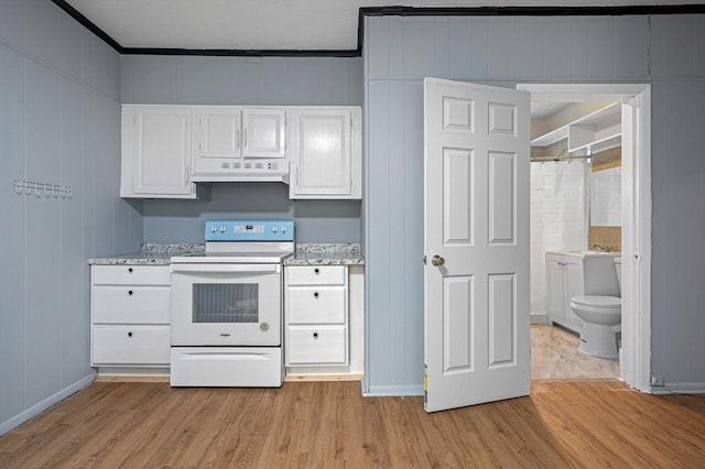 kitchen with electric range, under cabinet range hood, light wood-type flooring, crown molding, and white cabinetry