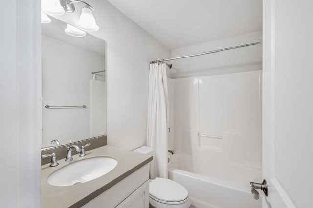 bathroom with toilet, shower / tub combo, and vanity