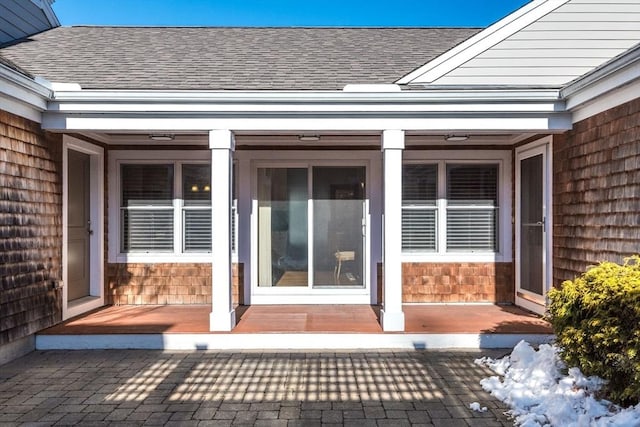 entrance to property with a shingled roof