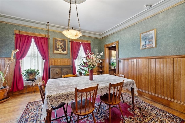 dining space with a healthy amount of sunlight, wainscoting, and hardwood / wood-style floors