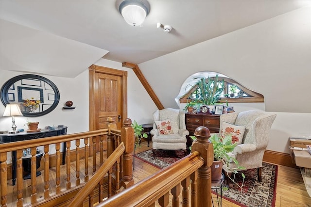 bedroom with light wood-type flooring and vaulted ceiling