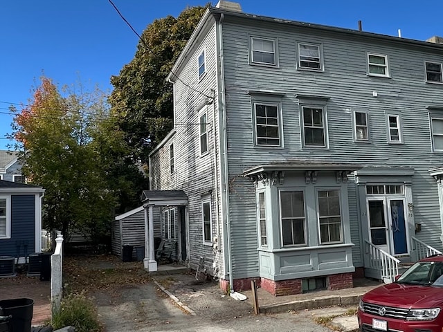 rear view of property with central AC