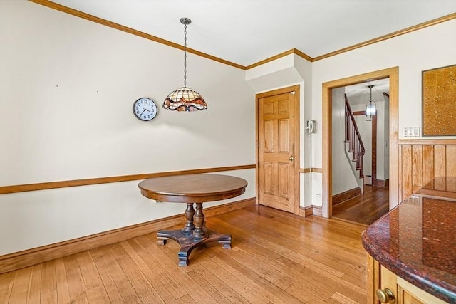 68 Barnard Ave, Watertown, MA 02472 - dining space featuring stairs, light wood-style flooring, and crown molding