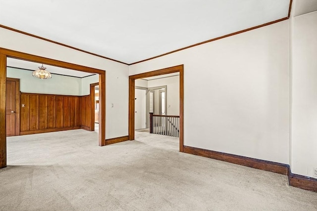 68 Barnard Ave, Watertown, MA 02472 - empty room featuring carpet floors, crown molding, wood walls, and a chandelier