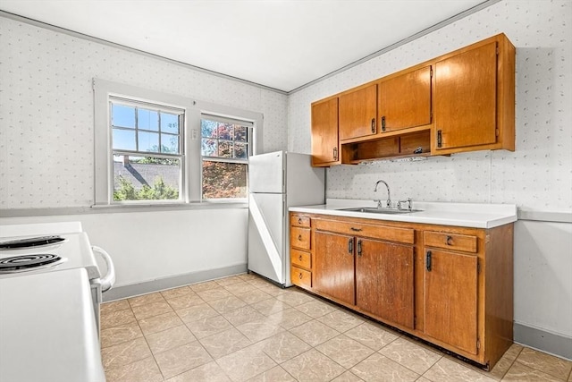 68 Barnard Ave, Watertown, MA 02472 - kitchen featuring white appliances, wallpapered walls, light countertops, and brown cabinets