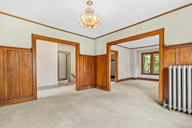 68 Barnard Ave, Watertown, MA 02472 - empty room featuring radiator, light colored carpet, a chandelier, and wooden walls